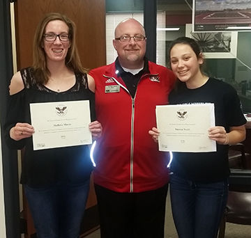 Fox High students Mallorie Mason, left, and Summer Smith, right, with principal Ryan Sherp.