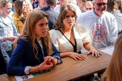 Britain's Princess Beatrice (L) and Princess Eugenie celebrated the coronation of King Charles III in 2023 at a street party in Windsor