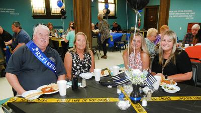 From left, Tim Lewis at his retirement luncheon, wife Linda Lewis and daughters Haley and Madison Lewis.