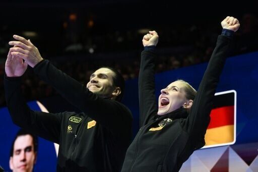 Germany’s Minerva Fabienne Hase and Nikita Volodin celebrate after winning pairs gold at the world figure skating championships in Prague