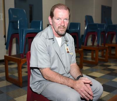 James Scott sits in a visitor room
