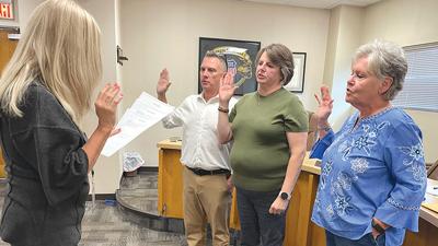 From left, Mike Bone, Autumn Blanchard and Kathy Smith are administered the oath of office by City Clerk Ann Houska.