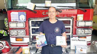 Cedar Hill Fire Battalion Chief John Griffith with some of the fire safety equipment the department has on hand to give away.