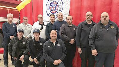 Firefighters from the Cedar Hill Fire Protection District show off the district’s new safe house, dedicated to the late William “Bill” James McCabe.