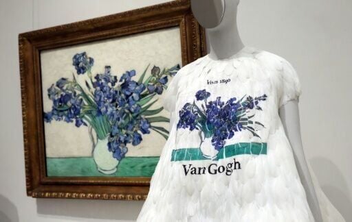 A Saint Laurent design is exhibited next to the 1890 painting 'Irises' by Vincent van Gogh at the Metropolitan Museum of Art's exhibit 'Costume Art'