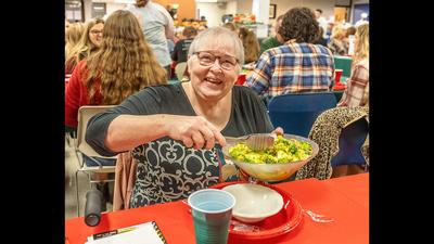 Helen Bollner of Fenton serves her winning recipe, Broccoli Crunch Salad, at the Leader Holiday Dinner.