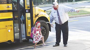Dunklin Superintendent Clint Freeman directs an elementary school student.