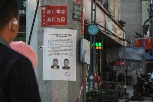 A wanted poster is seen on an electricity pole in Yayang township, Wenzhou city, in eastern China's Zhejiang province on January 9, 2026