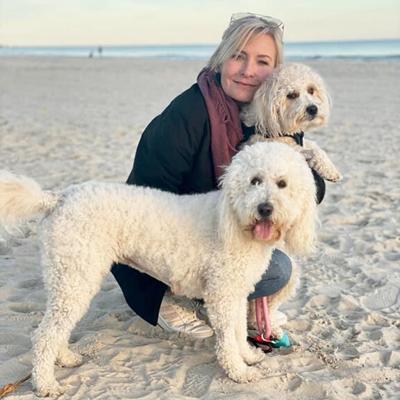 Holly Aucoin holds her dog, Michael, and her dog, Zoie, stands in front in this photo taken during a Thanksgiving family gathering in Cape San Blas, Fla., in November.