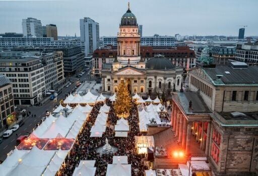 Visitors crowd the Christmas market on the Gendarmenmarkt in Berlin
