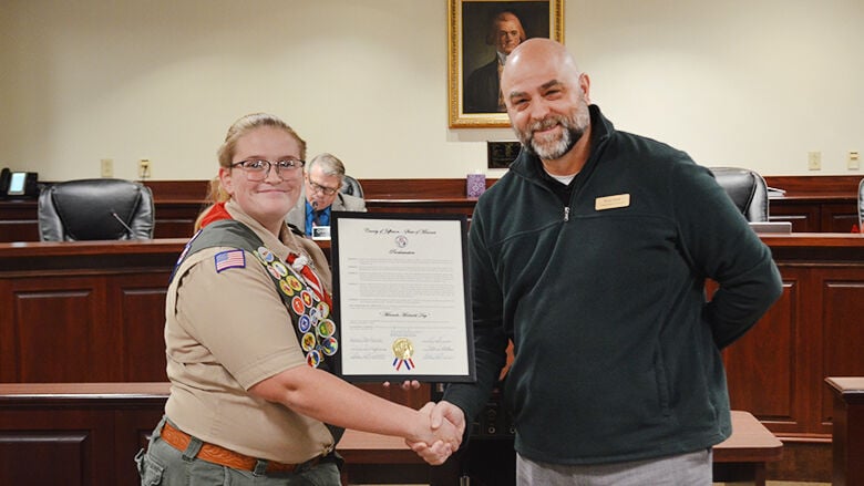 Miranda Machalek accepts a proclamation from Scott Seek, the District 5 representative on the Jefferson County Council.