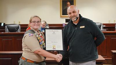 Miranda Machalek accepts a proclamation from Scott Seek, the District 5 representative on the Jefferson County Council.