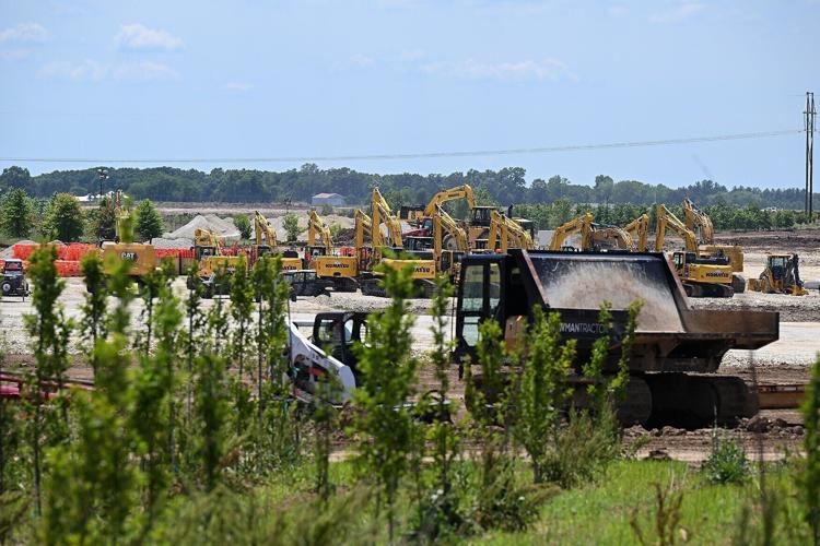 An army of large excavators and earth moving equipment
