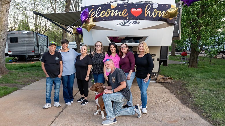 Dan Cuthern, Danielle Gherardini, Tracy Nelson, Vanessa Hathaway, Pamela Sophie, Michelle Lamb and Jerry Parsons pose in front of the new home these good Samaritans along with the community helped purchase for Dan.