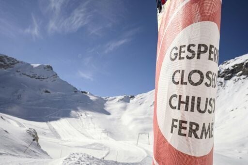 A warning sign stands near the ski lift prior to its demolition