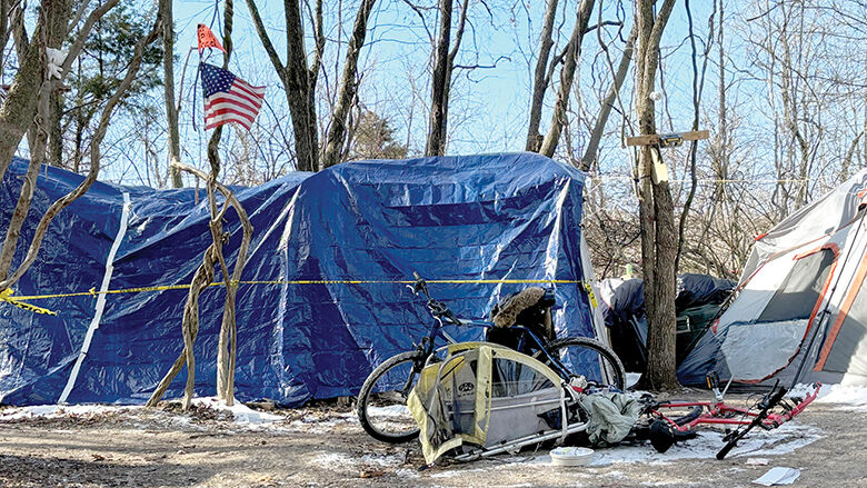 Heavy tarps help to protect tents from the weather at an encampment in Jefferson County.