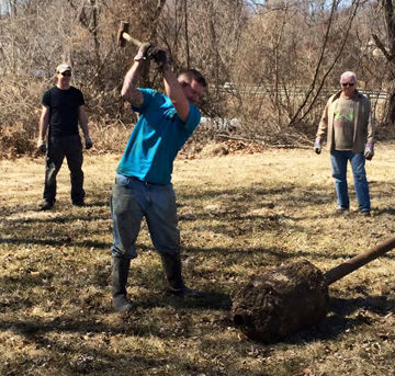 Gabriel Cotton breaks up concrete during the annual Arnold Stream Team winter cleanup.