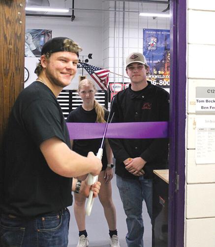 From left, Eureka High senior Spencer Leassner, senior Katelyn Milligan and junior Jacob Yallaly cut the ribbon on the new metal shop.