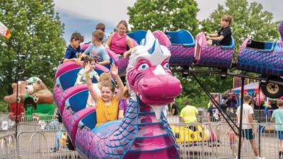 At the front of the carnival ride, Olivia Mattler, 8, of Arnold throws her hands in the air at the Holy Family Catholic Parish Picnic.