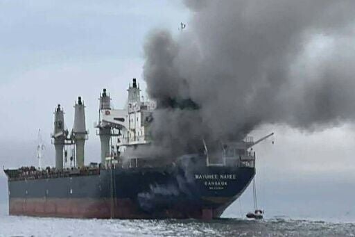 This handout photo taken on March 11, 2026 and released by the Royal Thai Navy shows smoke rising from the Thai bulk carrier 'Mayuree Naree' near the Strait of Hormuz after an attack