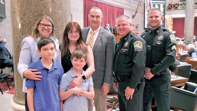 From left are Rep. Cecelie Williams, Cecilia Williams with Bentley and Mason, Gov. Mike Kehoe, Byrnes Mill Police Capt. Steve Schaffer and Sgt. Cody Umfress.