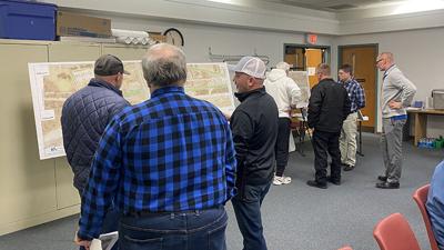 Mayor Buddy Russell, Heneghan Associates engineer Igor Gusev and City Administrator Jason Daniel discuss with residents about intersection improvements at Business 21 and Leon Hall Parkway.