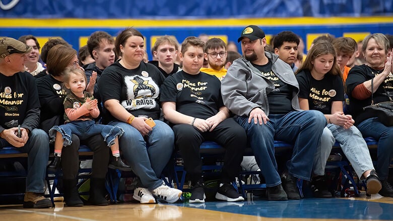 Jaxon, center, sits between his parents, Danielle and Ryan Menner.