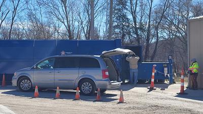 Byrnes Mill employee Zoey Rock, right, helps a man at the Recycling Center on Feb. 28.