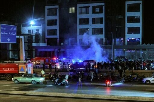 Rescuers rush to the site of an Israeli strike on a vehicle along the highway leading to Beirut's international airport