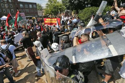 White nationalist demonstrators clash with counterdemonstrators at the entrance to Lee Park in Charlottesville, Va., on Aug. 12, 2017.