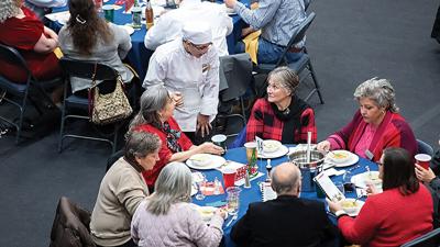 Jacinda Crawley of the Jefferson College Culinary Arts School offers drinks to those attending the 2025 Leader Holiday Dinner at the Field House at Jefferson College.