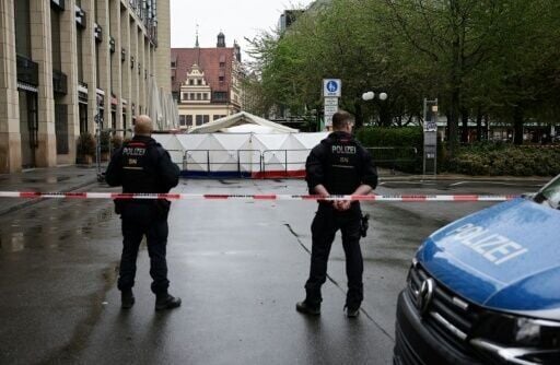 Police block off a street in Germany's Leipzig where a man drove a car into a crowd, killing two people