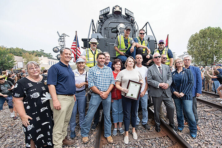 Local representatives and community leaders take a picture with members of the Union Pacific’s Big Boy locomotive team in downtown De Soto.