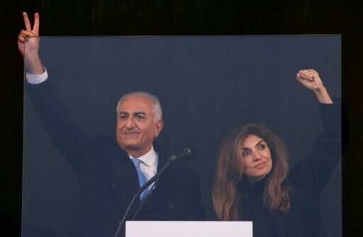 Iran's former crown prince and now key opposition figure Reza Pahlavi flashes the victory sign to a mass protest in Munich