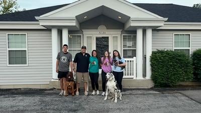 From left, Brody, Randy, Krista, Alayna and Sydney Green with their dogs, from left, Gus, Baron and Holly in front of Ruff Adventures.