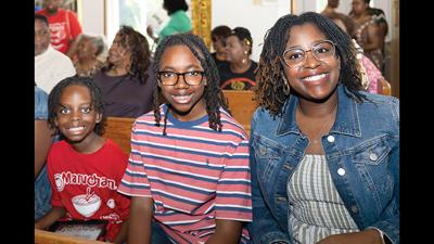 The fourth annual Quad City Juneteenth Celebration drew hundreds to the area with some attendees traveling from out of state. Pictured are Festus natives, Tranel Hill-Barrett and her sons, Tauras Scroggins Jr., 13, and Ethan Hill-Barrett, 7.
