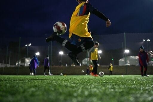 Children at football training in Kharkiv with coach and former soldier Oleksandr Andrushchenko