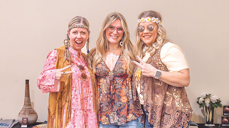 From left, Heather Lewis, Sky-Ann Williams and Lori Schellhase of De Soto dress in their hippie attire for the event.