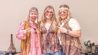 From left, Heather Lewis, Sky-Ann Williams and Lori Schellhase of De Soto dress in their hippie attire for the event.
