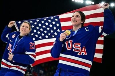 USA's Kendall Coyne (L) and Hilary Knight (R) celebrate after winning Olympic women's ice hockey gold in Milan