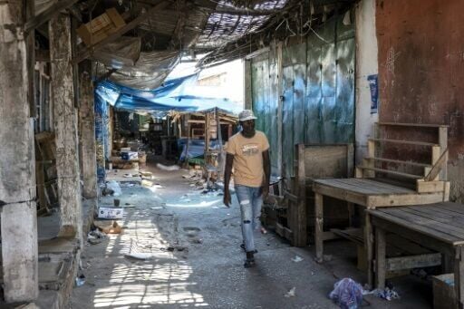 A pedestrian walks along a deserted market in Bissau on November 27, 2025, one day after a military coup