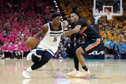 Minnesota's Anthony Edwards drives past San Antonio's Stephon Castle in the Timberwolves playoff upset