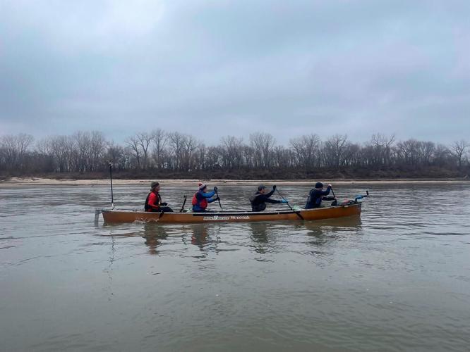 From left, Curt Leitz, Scott Duffus, Lád’a Zednik and Scott Miller paddle a canoe