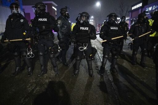 Minneapolis police deployed to face protesters outraged by the violent tactics of immigration officers in the city