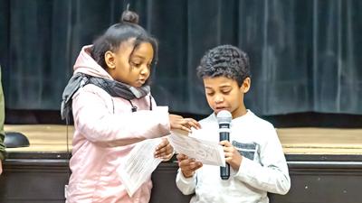 Olivia Anderson and Maksim Brown, both of Festus and members of Mt. Olive Missionary Baptist Church, read quotes from Martin Luther King Jr. at the celebration on Sunday.
