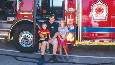 Herculaneum Fire Department firefighter Josh Kaiser poses with his children, Evan Kaiser and Emma Kaiser, on a Herculaneum firetruck during the 2021 event.