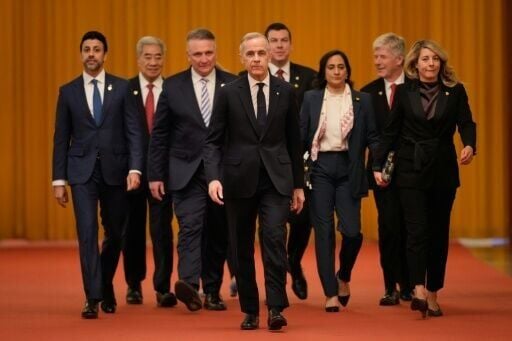Canada's Prime Minister Mark Carney (C) arrives for meeting with Chinese President Xi Jinping at the Great Hall of the People in Beijing