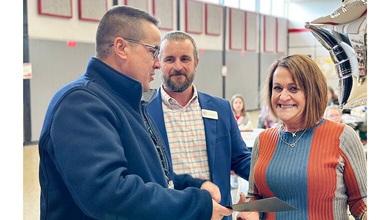 Fox C-6 School District Superintendent Paul Fregeau, left, presents Karen Jansen, a special education paraprofessional at Meramec Heights Elementary School, with Fox’s support staff member of the year award.