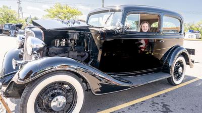 Sarah Sartors, 10, of Imperial sits in a 1933 Chevrolet sedan on May 9 during the Arnold Rotary Club car show in Arnold.