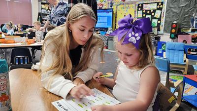 Ava Murawski works with Pond Elementary kindergarten student Sloan Flynn